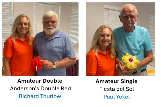Two men holding large fish at a fishing competition.